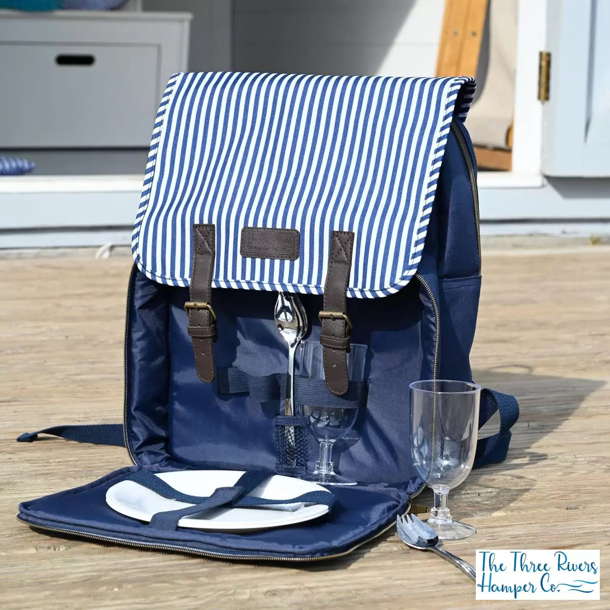 Navy and white striped Navigate Three Rivers 2 person picnic backpack with padded straps and open cutlery compartment.