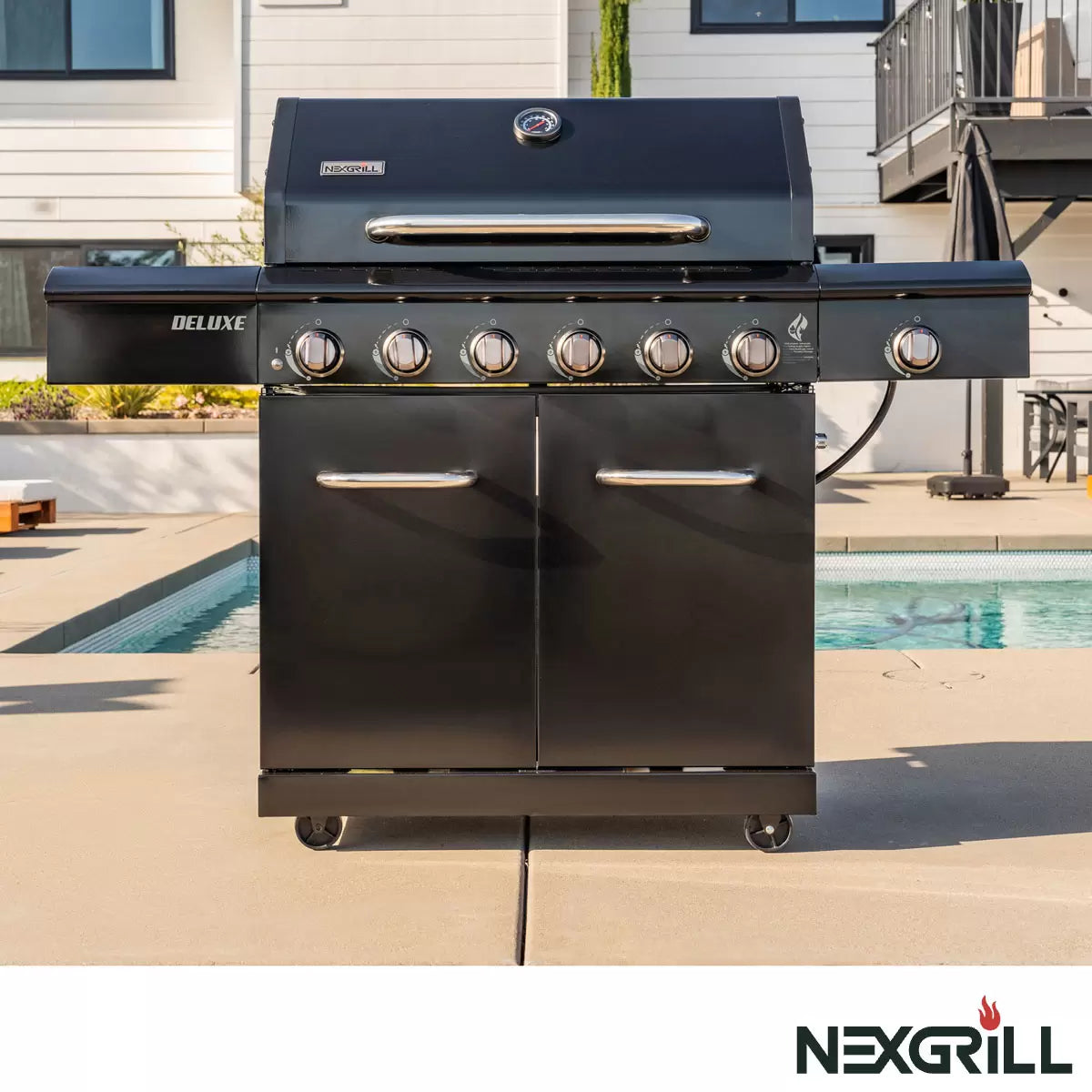 Nexgrill Deluxe 7 Burner Gas Barbecue Grill displayed on a patio, with the protective cover neatly folded nearby, ready for outdoor cooking.