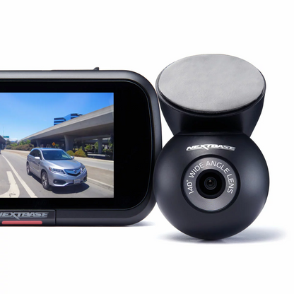 Sleek black Nextbase 422GW dash cam mounted on a windscreen showing its 2.5-inch touch screen panel, pictured alongside the compact rear window module and a circular polarising filter.