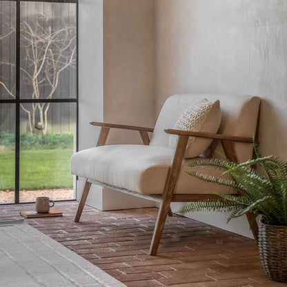 Front three-quarter view of the Gallery Neyland natural linen 2-seater sofa, showcasing its light-wash solid ash wood frame and soft textured natural cream linen cushions in a minimalist living room.