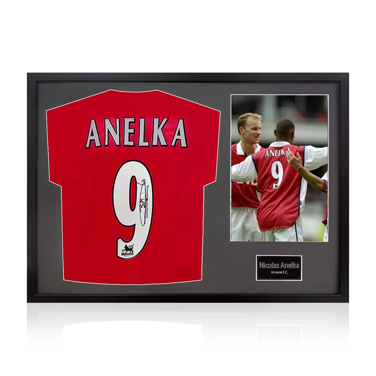 A professionally framed official Arsenal football shirt signed by Nicolas Anelka, displayed with a crisp white mount inside a sleek, high-quality wooden frame.