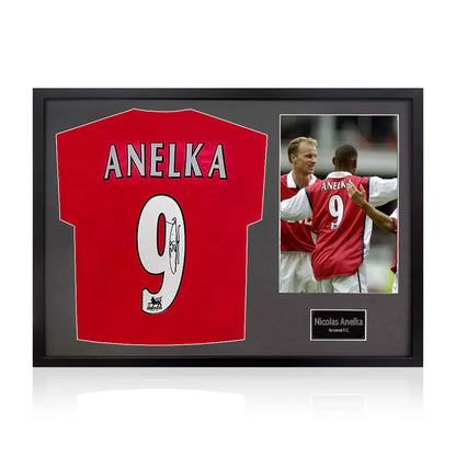 A professionally framed official Arsenal football shirt signed by Nicolas Anelka, displayed with a crisp white mount inside a sleek, high-quality wooden frame.