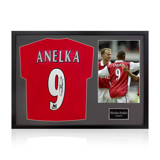 A professionally framed official Arsenal football shirt signed by Nicolas Anelka, displayed with a crisp white mount inside a sleek, high-quality wooden frame.
