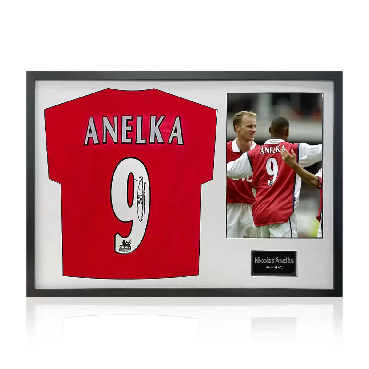 A professionally framed official Arsenal football shirt signed by Nicolas Anelka, displayed with a crisp white mount inside a sleek, high-quality wooden frame.