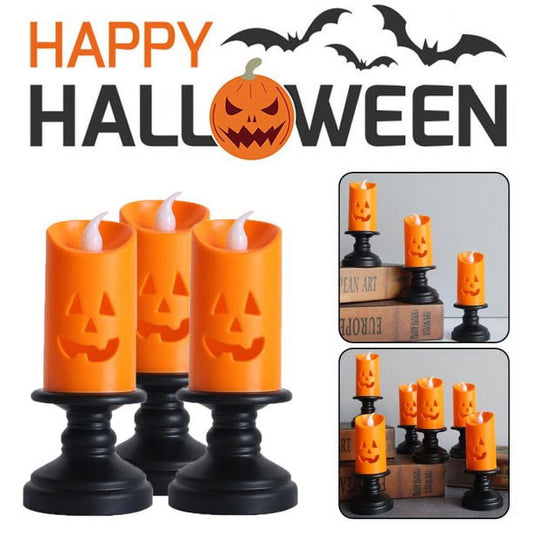 A Nightwill LED pumpkin candle light with a hollow ghost face design glowing softly on a festive party table.