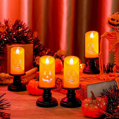 A Nightwill LED pumpkin candle light with a hollow ghost face design glowing softly on a festive party table.