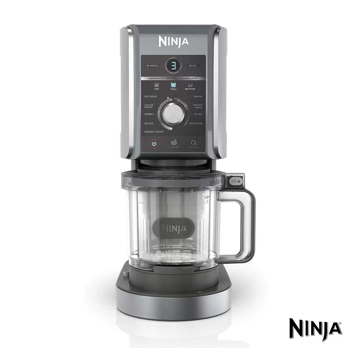 Front view of the matte silver Ninja CREAMi Deluxe NC501UK on a white kitchen counter next to a tub filled with fresh chocolate gelato and berries.
