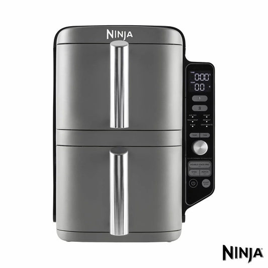 Front angle view of the silver Ninja SL400UK Double Stack XL 9.5L Air Fryer resting under kitchen cabinets with stacked wire racks visible inside open drawers.