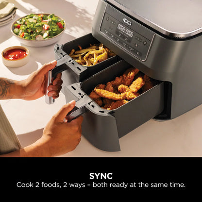 Front view of the Ninja DZ300UK Dual Zone Air Fryer in gun metal grey with both drawers closed sitting on a modern kitchen countertop.