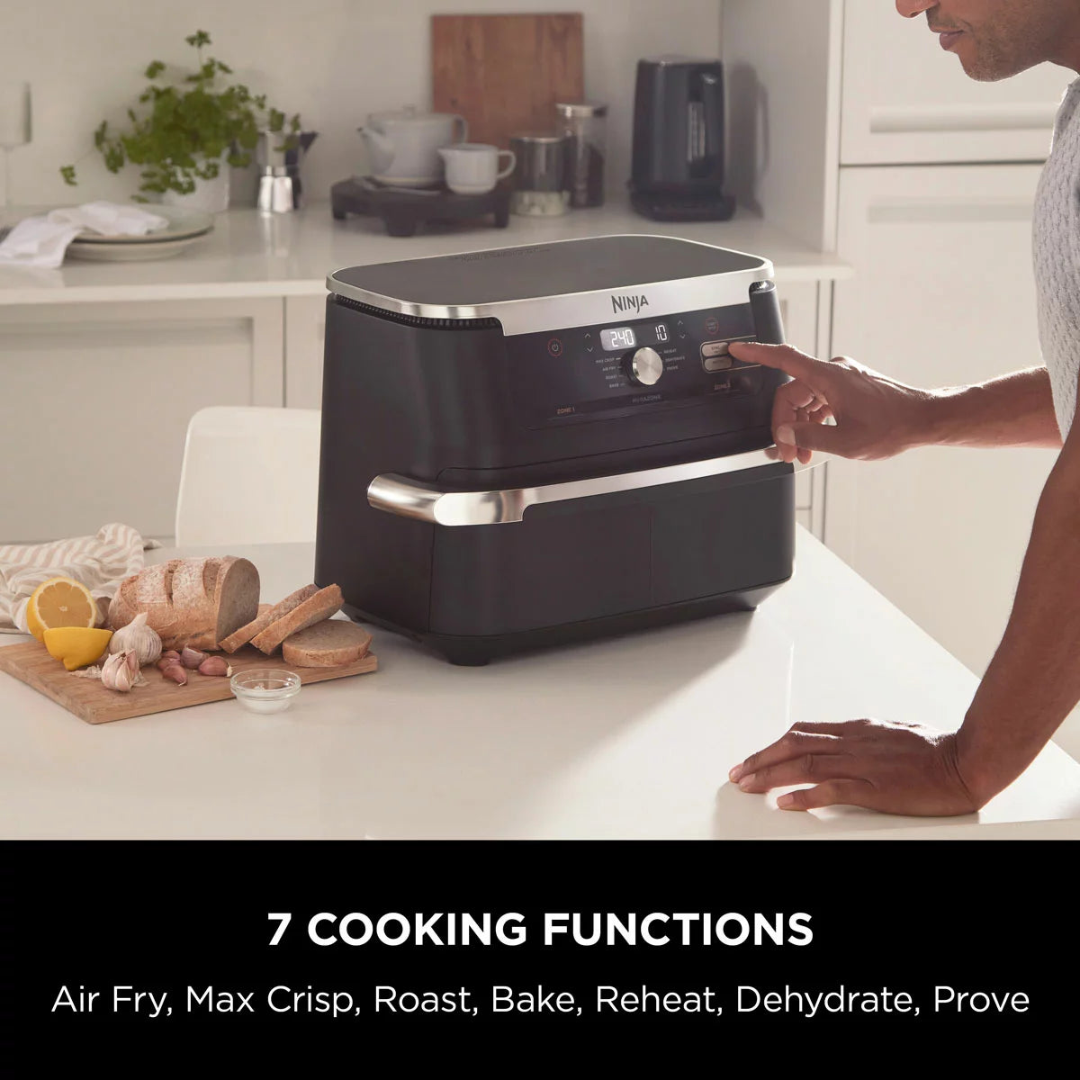 Ninja Foodi FlexDrawer 10.4L air fryer in black, shown with the dual-zone drawer pulled open to reveal the interior on a clean, modern kitchen countertop.