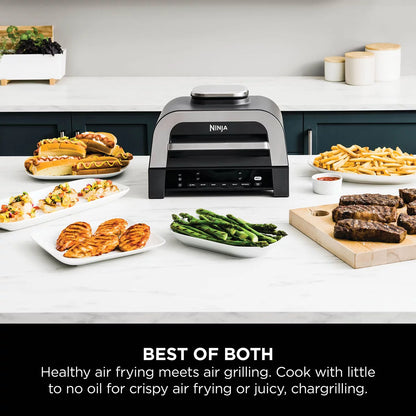 Front view of the grey Ninja DG551UK 6-in-1 MAX Grill and Air Fryer sitting on a modern kitchen countertop with digital probe attached.