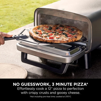 Front view of the grey Ninja MO203UK electric outdoor pizza oven with glowing interior light displaying a fresh 12-inch artisan pizza on the stone.