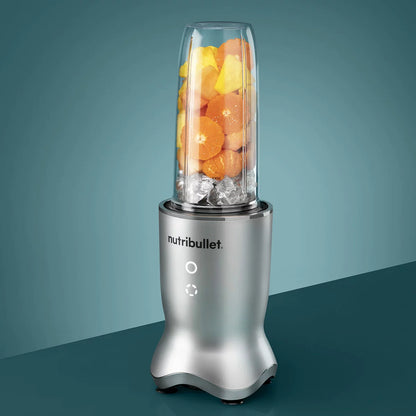 The sleek NutriBullet Ultra Deluxe blending base with a 900ml cup, stainless steel straws, and assorted lids arranged neatly on a modern kitchen surface.