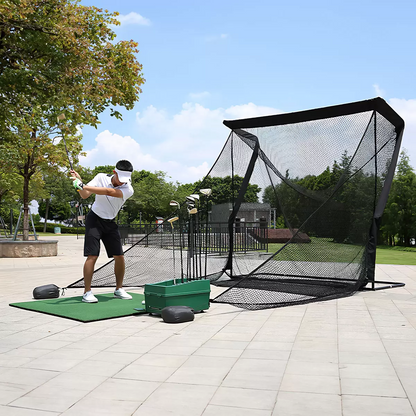 Front three-quarter view of the large black On Par Deluxe Home Golf Driving Net set up on a green garden lawn with its wide side protection wings fully extended.