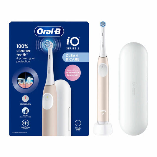 The Oral-B iO2 electric toothbrush in pink, displayed with its travel case and charging base against a clean, modern bathroom backdrop.
