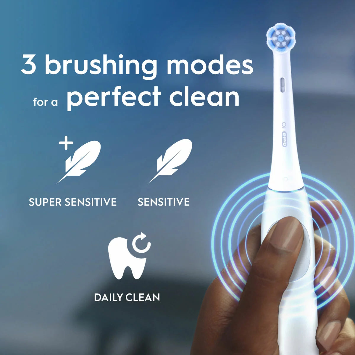 The Oral-B iO2 electric toothbrush in white, displayed with its travel case and charging base against a clean, modern bathroom backdrop.
