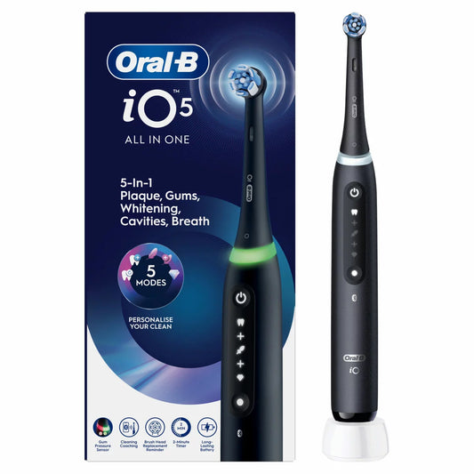 The Oral-B iO Series 5 electric toothbrush in matt black, shown with its Ultimate Clean brush head against a clean, modern bathroom background.