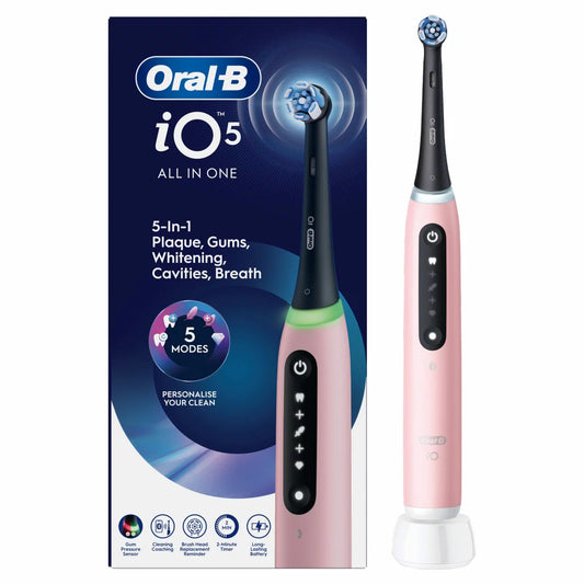 The Oral-B iO Series 5 electric toothbrush in pink, shown with its Ultimate Clean brush head against a clean, modern bathroom background.