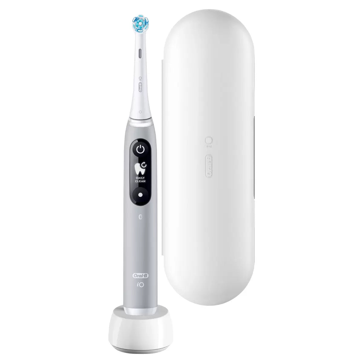Oral-B iO Series 6 electric toothbrush in grey, displayed next to a travel case and a fresh Ultimate Clean brush head on a clean white surface.
