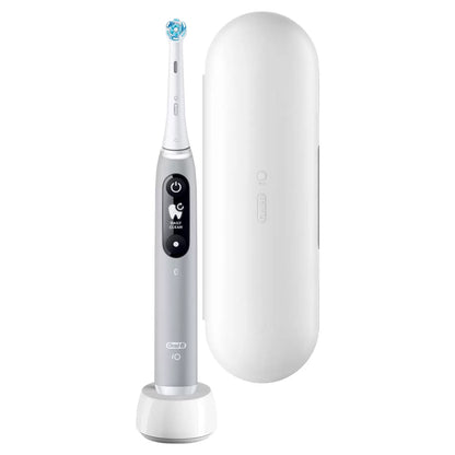 Oral-B iO Series 6 electric toothbrush in grey, displayed next to a travel case and a fresh Ultimate Clean brush head on a clean white surface.