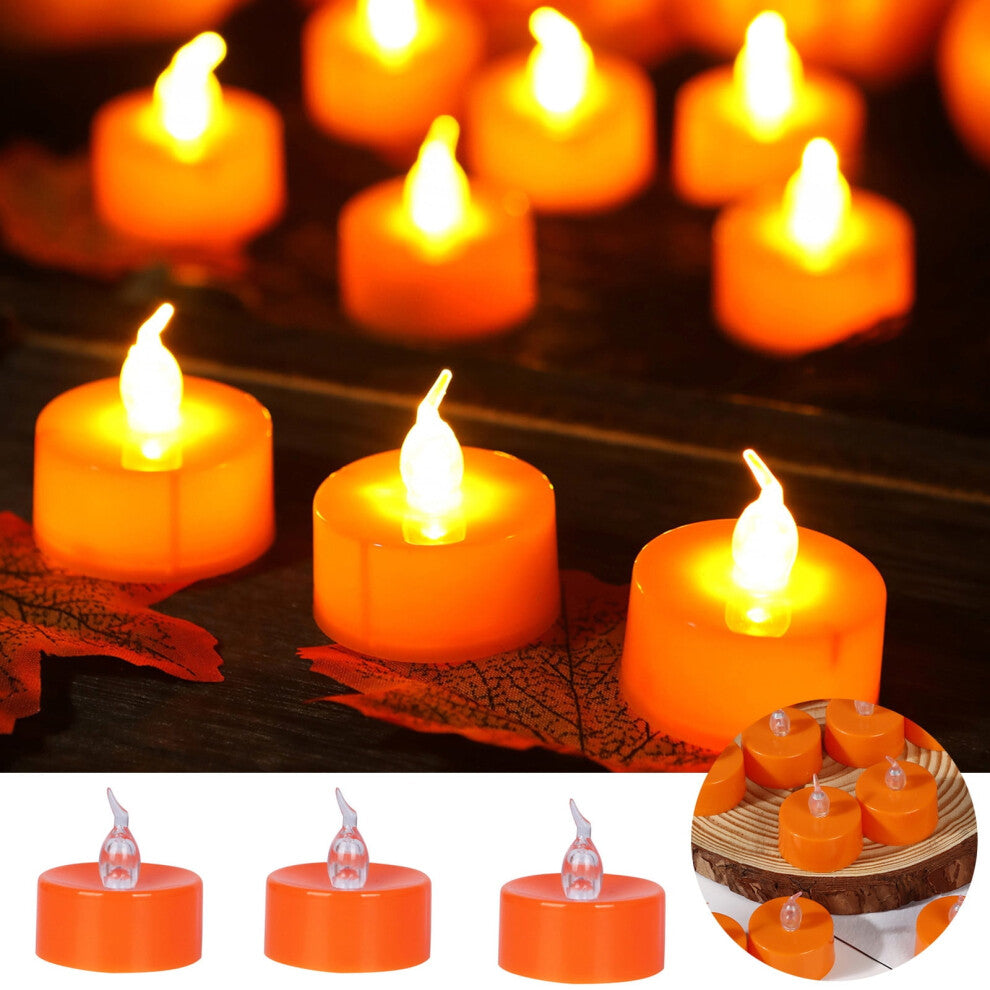 A 12-pack of orange flameless LED tea lights glowing with a warm flickering light on a festive autumn tabletop.
