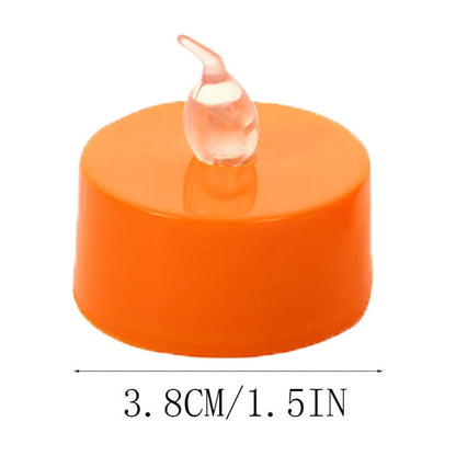 A 12-pack of orange flameless LED tea lights glowing with a warm flickering light on a festive autumn tabletop.