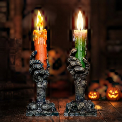 An orange skull and ghosts Halloween party candle light glowing on a dark wooden table, showcasing its festive holiday print and warm illumination