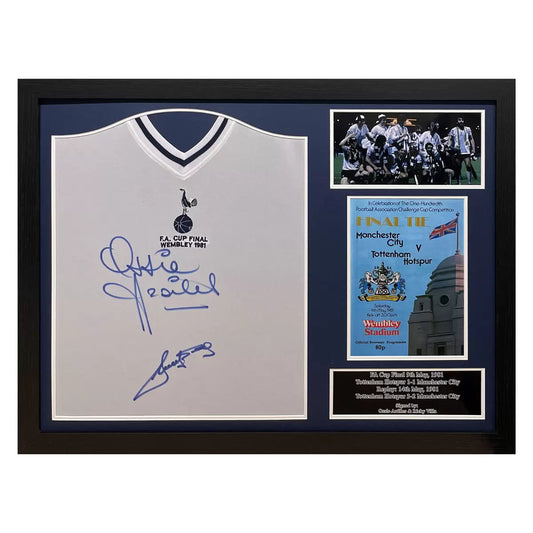 A professionally framed 1981 Tottenham Hotspur jersey, dual-signed by Ossie Ardiles and Ricky Villa, displayed in a high-quality wooden frame against a neutral wall.