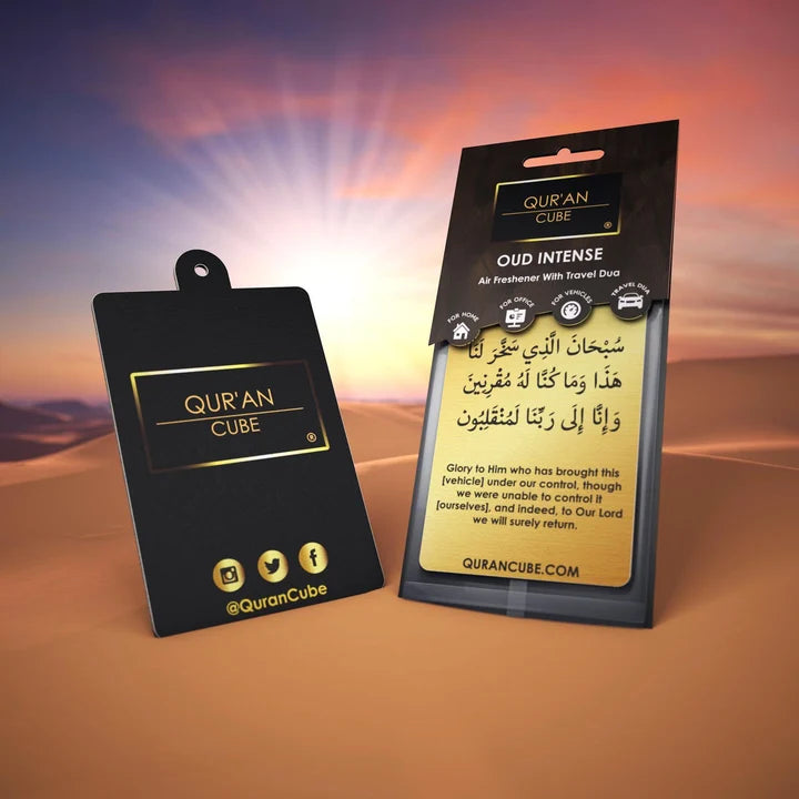 Quran Cube Oud fragrance hanging car air freshener card printed with Arabic Safar Dua script suspended against a dark car dashboard interior.