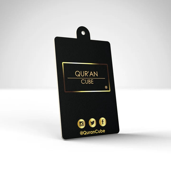 Quran Cube Oud fragrance hanging car air freshener card printed with Arabic Safar Dua script suspended against a dark car dashboard interior.