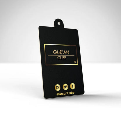 Quran Cube Oud fragrance hanging car air freshener card printed with Arabic Safar Dua script suspended against a dark car dashboard interior.