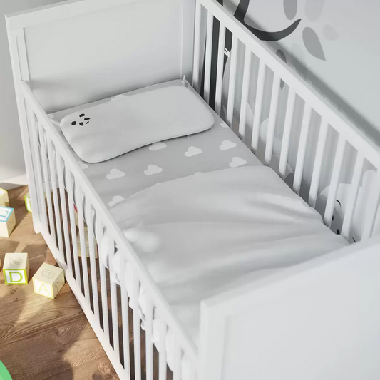Close-up of a toddler resting comfortably on the ultra-soft, white bamboo fabric cover of the Panda Baby pillow.