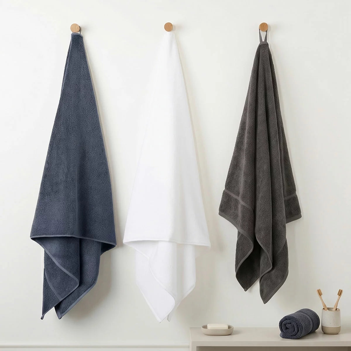 A plush 2-pack stack of textured Panda bamboo and cotton blend bath sheets neatly folded on a modern wooden bathroom vanity.