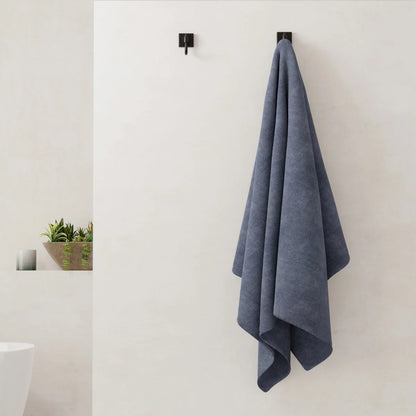 A plush 2-pack stack of textured Panda bamboo and cotton blend bath sheets neatly folded on a modern wooden bathroom vanity.