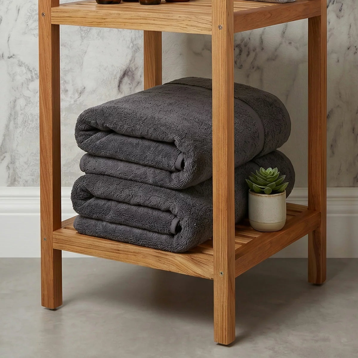 A plush 2-pack stack of textured Panda bamboo and cotton blend bath sheets neatly folded on a modern wooden bathroom vanity