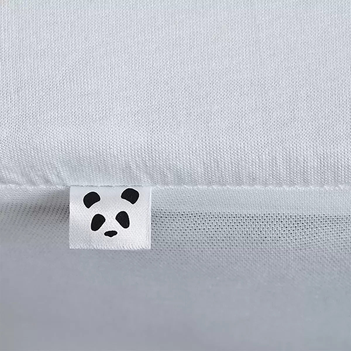 Soft white Panda Bamboo Mattress Protector showing its textured bamboo surface and deep fitted skirt fitted on a modern mattress.