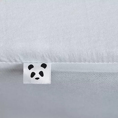 Soft white Panda Bamboo Mattress Protector showing its textured bamboo surface and deep fitted skirt fitted on a modern mattress.