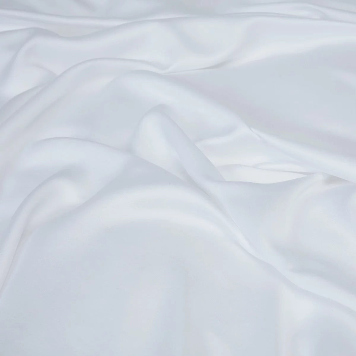 Crisp white Panda 100 percent organic bamboo fitted sheet securely pulled tight over a deep mattress corner showing smooth texture.