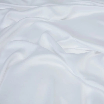 Crisp white Panda 100 percent organic bamboo fitted sheet securely pulled tight over a deep mattress corner showing smooth texture.