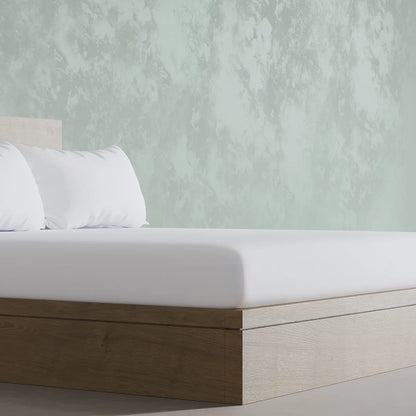 Crisp white Panda 100 percent organic bamboo fitted sheet securely pulled tight over a deep mattress corner showing smooth texture.