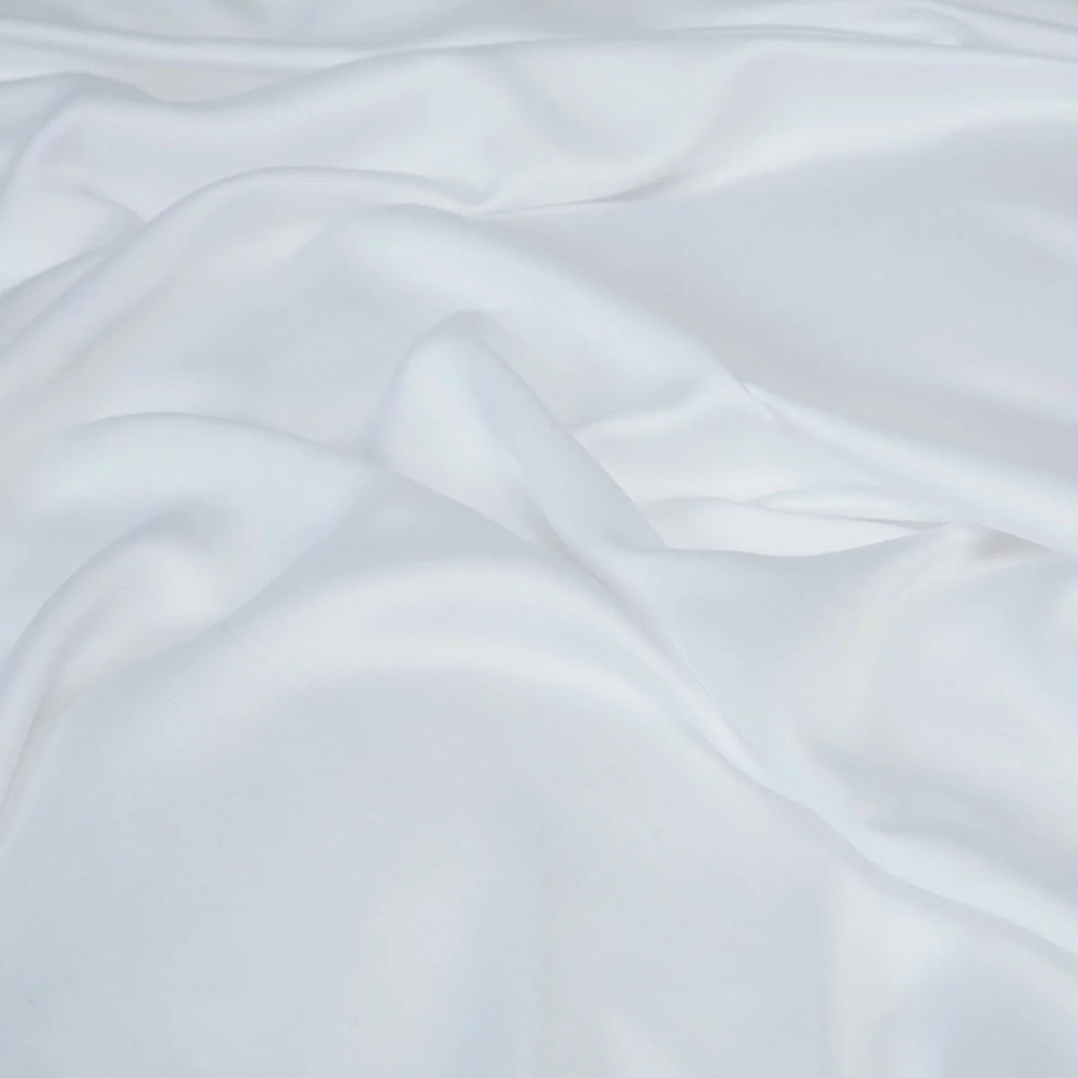 Crisp white Panda 100 percent bamboo flat sheet folded neatly on a bed showing its silky texture and natural luster.