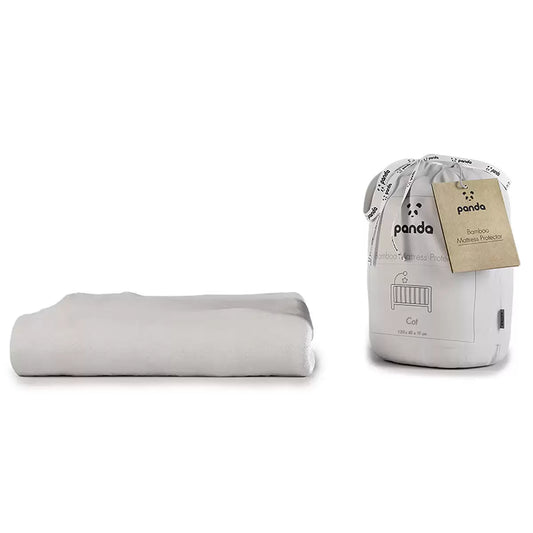 White Panda Children's Bamboo Mattress Protector neatly fitted over a single bed mattress in a sunlit wooden frame.