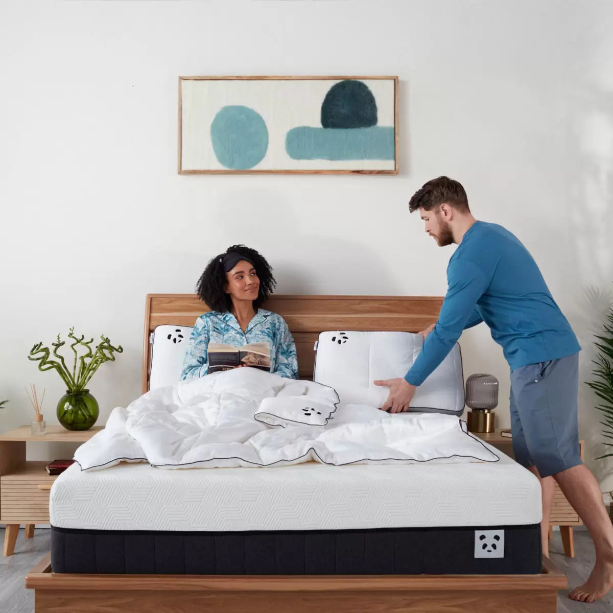 Panda Hybrid Memory Foam Pillow showcasing its white bamboo cover and distinct grey 3D mesh border on a modern bed