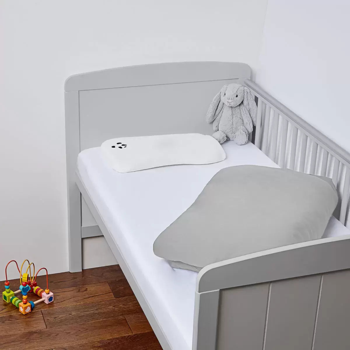 Soft white Panda Children's 100% Bamboo Duvet Cover neatly folded on a cot bed displaying its silky sateen texture.