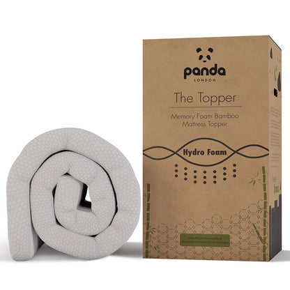 Corner view of the white Panda Memory Foam Bamboo Mattress Topper showing its textured bamboo zip cover, black anti-slip base, and elastic corner strap on a modern bed.