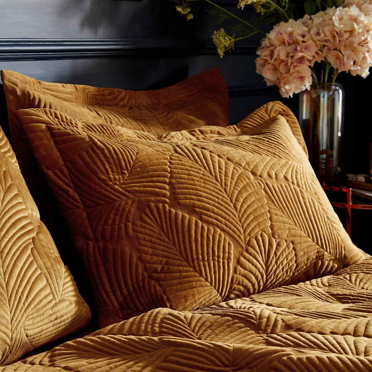 Rich gold Paoletti velvet duvet cover featuring intricate palm embroidery with matching Oxford pillowcases arranged on a bed.