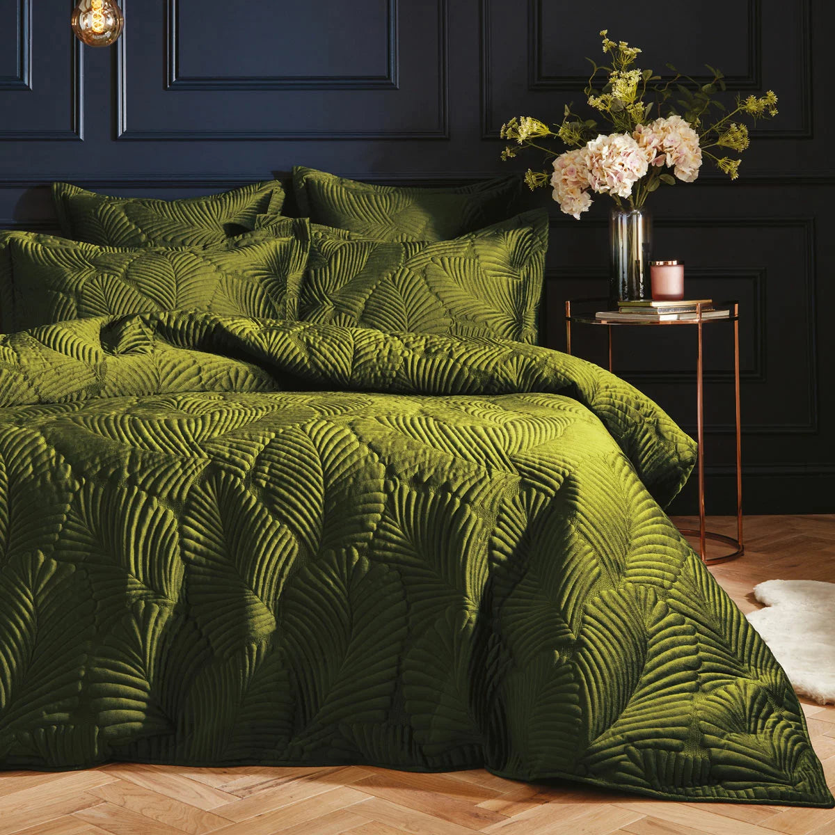 Earthy moss green Paoletti velvet duvet cover featuring intricate palm embroidery with matching Oxford pillowcases styled on a modern bed.
