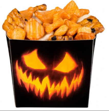 Six black paper Halloween party trays featuring orange jack-o'-lantern pumpkin faces arranged on a table with party snacks.