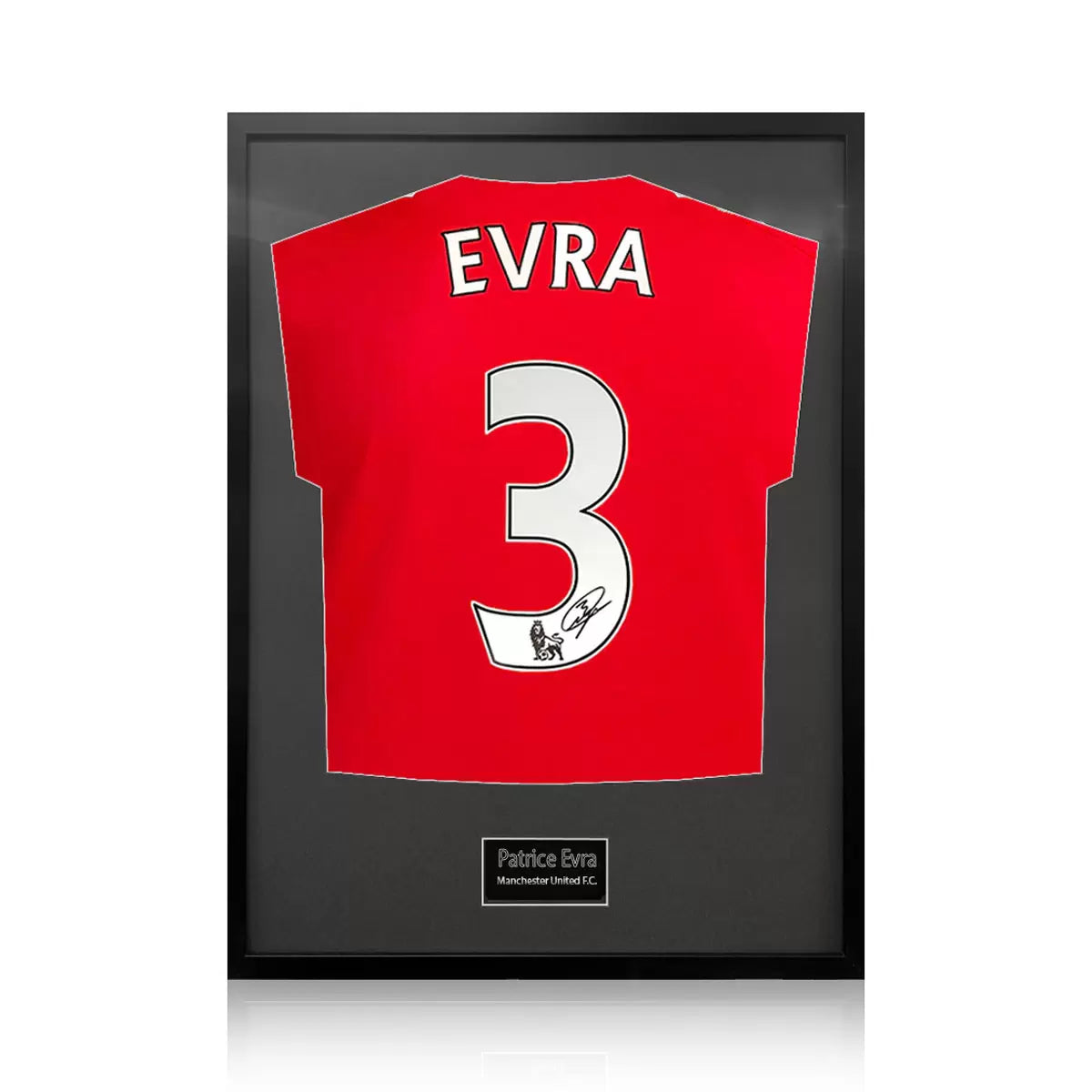 A professionally framed Manchester United football shirt signed by Patrice Evra, centered within a deep-set frame featuring a crisp white mount board against a neutral wall.