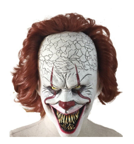 Front view of the adult Pennywise IT clown latex mask featuring realistic white face paint, creepy red smile lines, and bright red synthetic hair.